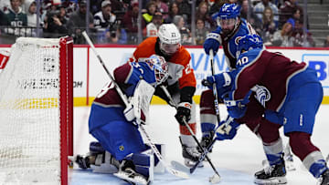Feb 2, 2025; Denver, Colorado, USA; Philadelphia Flyers left wing Noah Cates (27) attempts to score past Colorado Avalanche goaltender Mackenzie Blackwood (39) as defenseman Keaton Middleton (67) and defenseman Sam Malinski (70) defend in the third period at Ball Arena.