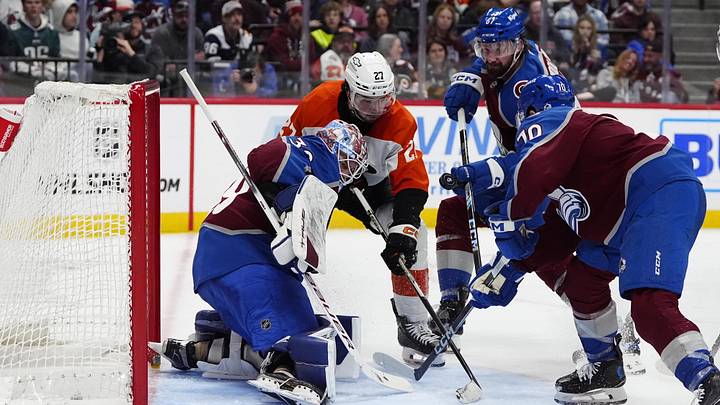 Feb 2, 2025; Denver, Colorado, USA; Philadelphia Flyers left wing Noah Cates (27) attempts to score past Colorado Avalanche goaltender Mackenzie Blackwood (39) as defenseman Keaton Middleton (67) and defenseman Sam Malinski (70) defend in the third period at Ball Arena.