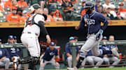 Sep 25, 2025; Baltimore, Maryland, USA; Tampa Bay Rays designated hitter Yandy Diaz (2) scores during the third inning in front of Baltimore Orioles catcher Alex Jackson (70) at Oriole Park at Camden Yards. 
