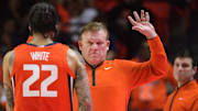 Feb 25, 2025; Champaign, Illinois, USA;  Illinois Fighting Illini head coach Brad Underwood reacts with player Illinois Fighting Illini guard Tre White (22)  during the second half at State Farm Center. Mandatory Credit: Ron Johnson-Imagn Images