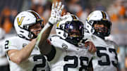 Nov 29, 2025; Knoxville, Tennessee, USA;  Vanderbilt Commodores quarterback Diego Pavia (2), running back Sedrick Alexander (28) and offensive lineman Jordan White (53) celebrate a touchdown against the Tennessee Volunteers during the second half at Neyland Stadium. Mandatory Credit: Randy Sartin-Imagn Images