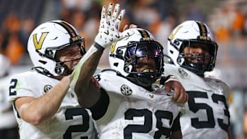 Nov 29, 2025; Knoxville, Tennessee, USA;  Vanderbilt Commodores quarterback Diego Pavia (2), running back Sedrick Alexander (28) and offensive lineman Jordan White (53) celebrate a touchdown against the Tennessee Volunteers during the second half at Neyland Stadium. Mandatory Credit: Randy Sartin-Imagn Images