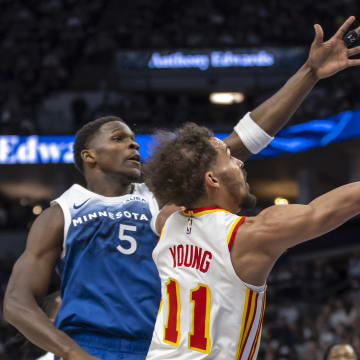Apr 12, 2024; Minneapolis, Minnesota, USA; Atlanta Hawks guard Trae Young (11) drives to the basket past Minnesota Timberwolves guard Anthony Edwards (5) in the first half at Target Center. Mandatory Credit: Jesse Johnson-USA TODAY Sports
