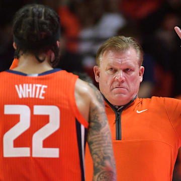 Feb 25, 2025; Champaign, Illinois, USA;  Illinois Fighting Illini head coach Brad Underwood reacts with player Illinois Fighting Illini guard Tre White (22)  during the second half at State Farm Center. Mandatory Credit: Ron Johnson-Imagn Images