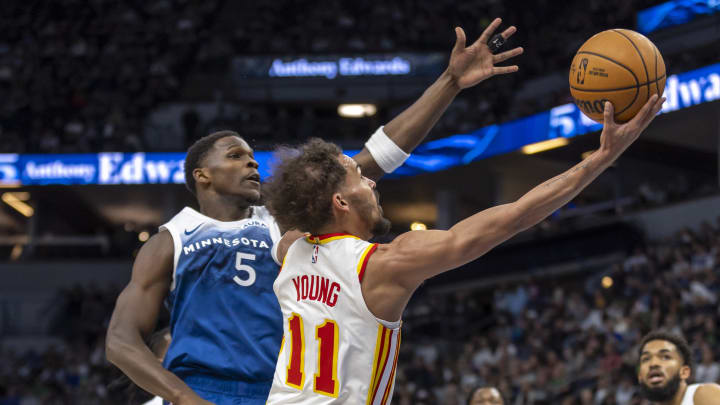 Apr 12, 2024; Minneapolis, Minnesota, USA; Atlanta Hawks guard Trae Young (11) drives to the basket past Minnesota Timberwolves guard Anthony Edwards (5) in the first half at Target Center. Mandatory Credit: Jesse Johnson-USA TODAY Sports