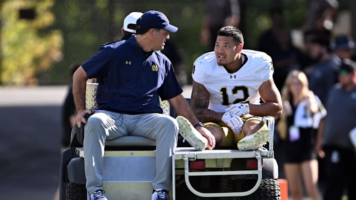 Sep 14, 2024; West Lafayette, Indiana, USA; Notre Dame Fighting Irish defensive lineman Jordan Botelho (12) is carted off the field with an apparent injury during the second quarter against the Purdue Boilermakers at Ross-Ade Stadium. Mandatory Credit: Marc Lebryk-Imagn Images