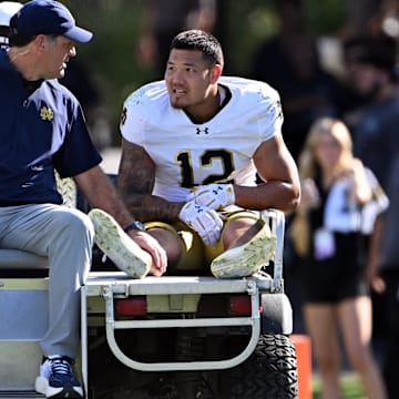 Sep 14, 2024; West Lafayette, Indiana, USA; Notre Dame Fighting Irish defensive lineman Jordan Botelho (12) is carted off the field with an apparent injury during the second quarter against the Purdue Boilermakers at Ross-Ade Stadium. 