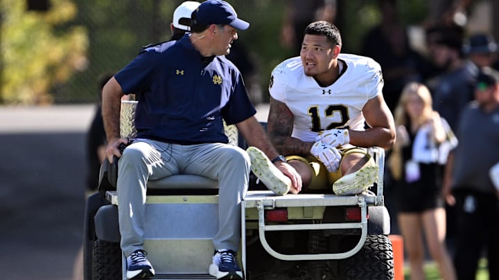 Sep 14, 2024; West Lafayette, Indiana, USA; Notre Dame Fighting Irish defensive lineman Jordan Botelho (12) is carted off the field with an apparent injury during the second quarter against the Purdue Boilermakers at Ross-Ade Stadium. 