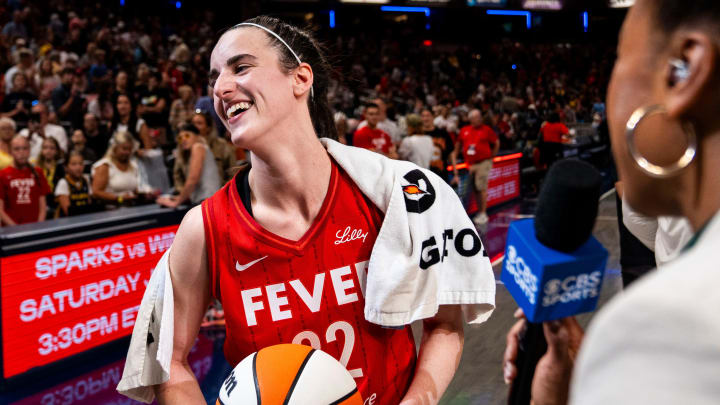 Jul 6, 2024; Indianapolis, Indiana, USA; Indiana Fever guard Caitlin Clark (22) smiles in an interview after becoming the first rookie to have a triple-double during a game against the New York Liberty at Gainbridge Fieldhouse. 