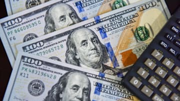 In this photo illustration, some 100 US dollar bills are...