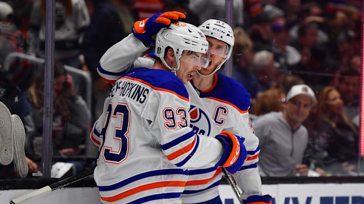 Apr 29, 2025; Los Angeles, California, USA; Edmonton Oilers center Ryan Nugent-Hopkins (93) celebrates his empty net goal scored agaisnt the Los Angeles Kings with center Connor McDavid (97) during the third period in game five of the first round of the 2025 Stanley Cup Playoffs at Crypto.com Arena. Mandatory Credit: Gary A. Vasquez-Imagn Images