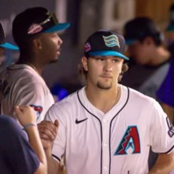 Arizona Diamondbacks pitching prospect Dylan Ray fist bumps teammates  in dugout after Arizona Fall League outing at Salt River Fields Oct 8. 2024