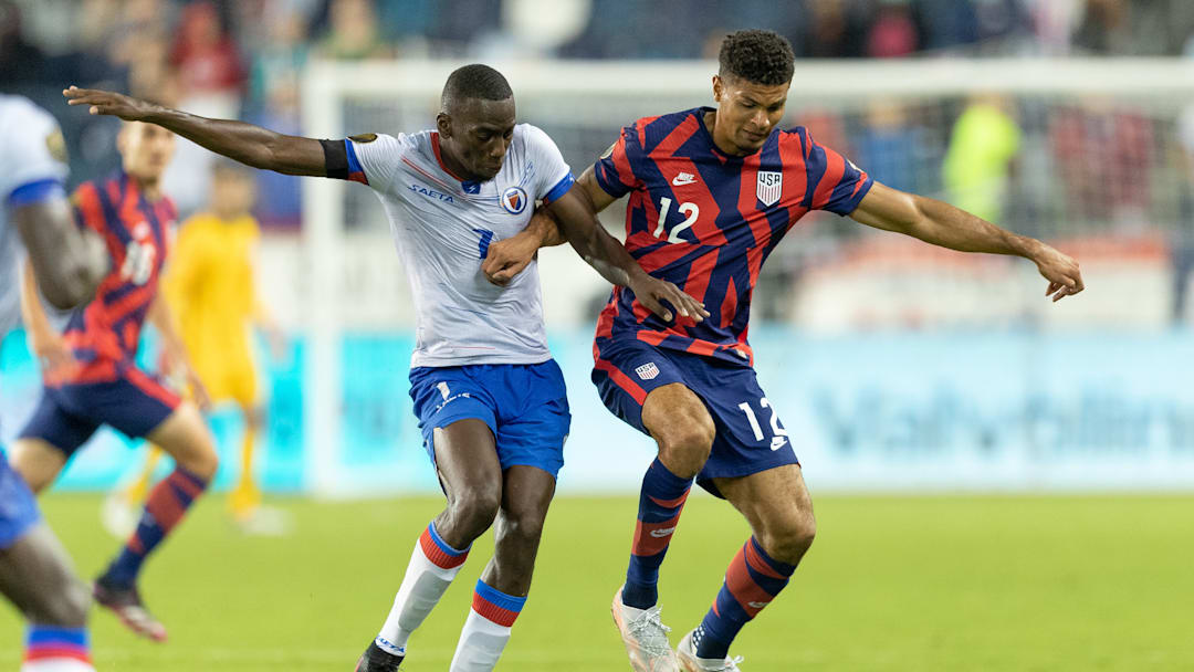 Miles Robinson shields the ball from a Haitian player during the 2021 Gold Cup.