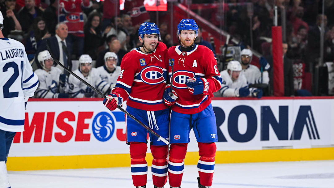 Montreal, Quebec, CAN; Montreal Canadiens defenseman Mike Matheson celebrates a goal with center Nick Suzuki against the Toronto Maple Leafs during the first period at Bell Centre. Credit: David Kirouac-Imagn Images
