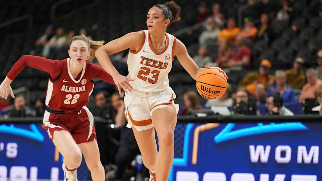 Mar 6, 2026; Greenville, SC, USA; Texas Longhorns guard Aaliyah Crump (23) brings the ball up court chased by Alabama Crimson Tide guard Karly Weathers (22) during the second half at Bon Secours Wellness Arena. Mandatory Credit: Jim Dedmon-Imagn Images