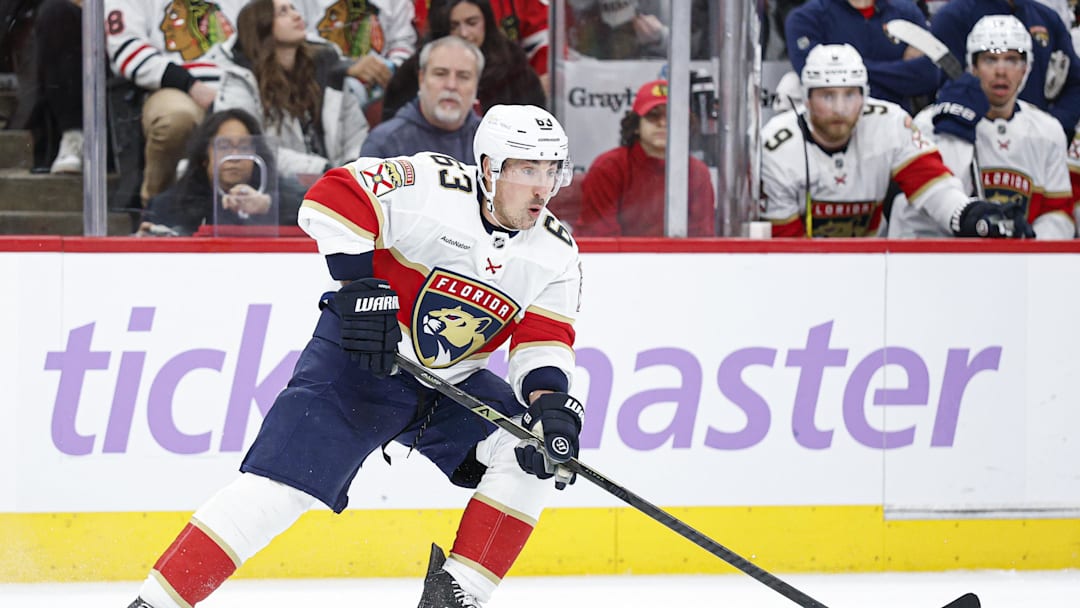 Jan 25, 2026; Chicago, Illinois, USA; Florida Panthers left wing Brad Marchand (63) looks to pass the puck against the Chicago Blackhawks during the second period at United Center. Mandatory Credit: Kamil Krzaczynski-Imagn Images