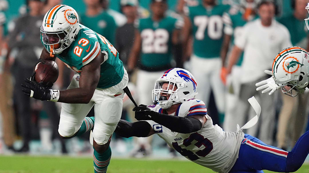 Buffalo Bills linebacker Terrel Bernard (43) reaches for Miami Dolphins running back Jeff Wilson Jr. (23) during the first half at Hard Rock Stadium in 2024.