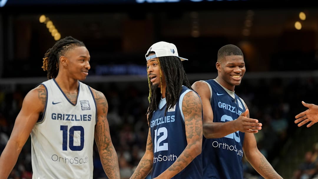 Grizzlies' Javon Small (10) and Ja Morant (12) talk as they and Cedric Coward (23) walk off the court during open practice at the FedExForum on October 4, 2025, in Memphis, Tenn.