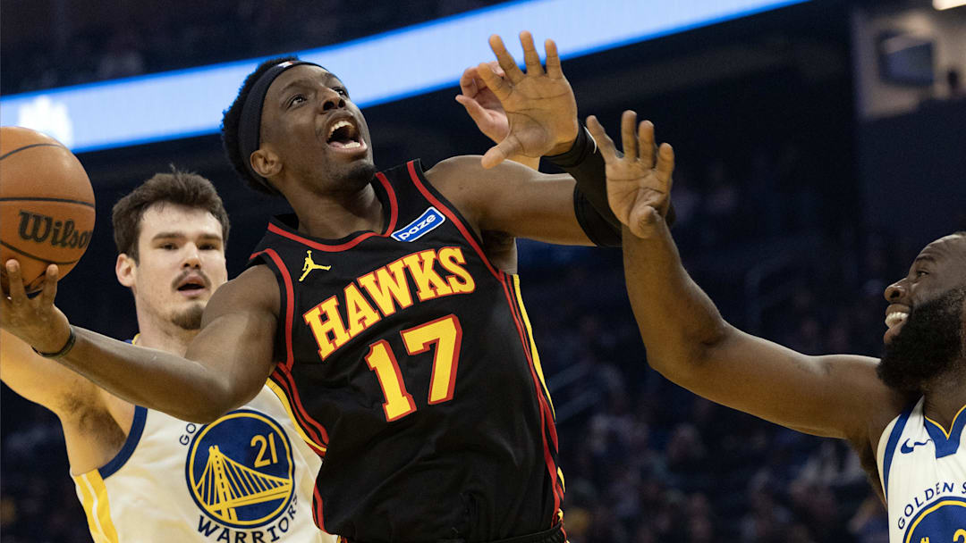 Jan 11, 2026; San Francisco, California, USA; Atlanta Hawks forward Onyeka Okongwu (17) drives to the basket between Golden State Warriors defenders Quinten Post (21) and Draymond Green (23) during the first quarter at Chase Center. Mandatory Credit: D. Ross Cameron-Imagn Images