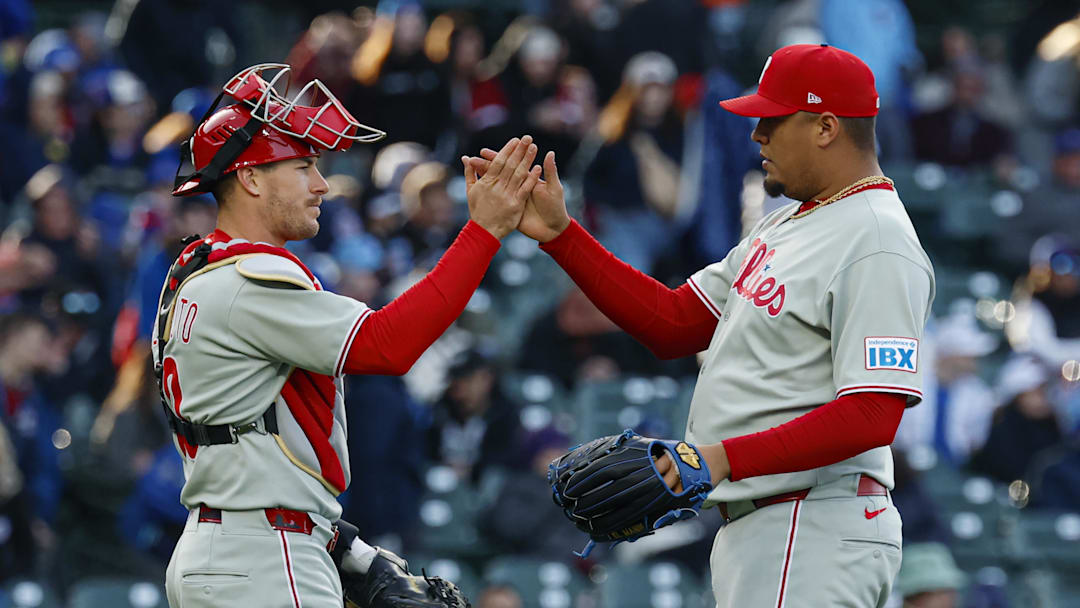 Apr 26, 2025; Chicago, Illinois, USA; Philadelphia Phillies pitcher Carlos Hernández (35) celebrates with catcher J.T. Realmuto (10) team's win against the Chicago Cubs at Wrigley Field