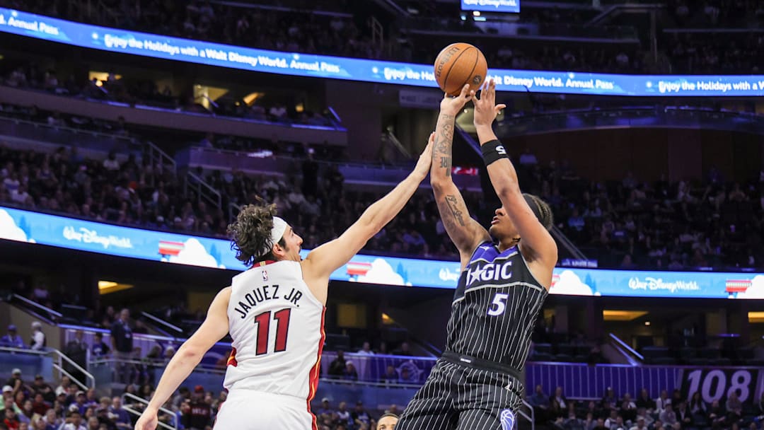 Dec 9, 2025; Orlando, Florida, USA; Orlando Magic forward Paolo Banchero (5) shoots against Miami Heat forward Jaime Jaquez Jr. (11) during the second half at Kia Center. Mandatory Credit: Mike Watters-Imagn Images