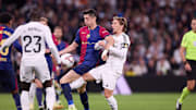 Robert Lewandowski (L) of FC Barcelona and Luka Modric (R)...