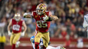 December 30, 2024; Santa Clara, California, USA; San Francisco 49ers tight end George Kittle (85) is tackled by Detroit Lions safety Ifeatu Melifonwu (6) during the fourth quarter at Levi's Stadium. Mandatory Credit: Kyle Terada-Imagn Images