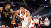 Mar 12, 2025; Indianapolis, IN, USA;  Rutgers Scarlet Knights guard Dylan Harper (2) dribbles the ball while USC Trojans guard Wesley Yates III (6) defends in the second half at Gainbridge Fieldhouse. Mandatory Credit: Trevor Ruszkowski-Imagn Images