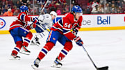 Sep 30, 2023; Montreal, Quebec, CAN; Montreal Canadiens defenseman David Reinbacher (64) plays the puck against the Toronto Maple Leafs during the third period at Bell Centre. Mandatory Credit: David Kirouac-Imagn Images