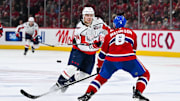 Apr 27, 2025; Montreal, Quebec, CAN; Washington Capitals defenseman John Carlson (74) shoots the puck beside Montreal Canadiens defenseman Mike Matheson (8) during the second period in game four of the first round of the 2025 Stanley Cup Playoffs at Bell Centre. Mandatory Credit: David Kirouac-Imagn Images