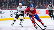 Nov 11, 2025; Montreal, Quebec, CAN; Montreal Canadiens center Alex Newhook (15) plays the puck against Los Angeles Kings right wing Joel Armia (40) during the first period at Bell Centre. Mandatory Credit: David Kirouac-Imagn Images
