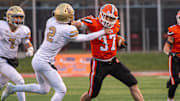 Byron's Caden Considine fends off Mt. Carmel defender Blayne Sisson on a run during the first quarter of the Class 3A championship game on Friday, Nov. 24, 2023 at Hancock Stadium in Bloomington.