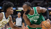 Jan 8, 2024; Indianapolis, Indiana, USA; Boston Celtics guard Jaylen Brown (7) holds the ball while getting guarded by Indiana Pacers wing Aaron Nesmith.