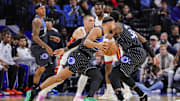 Dec 9, 2025; Orlando, Florida, USA; Orlando Magic guard Jalen Suggs (4) drives past Miami Heat guard Tyler Herro (14) during the first quarter at Kia Center. Mandatory Credit: Mike Watters-Imagn Images