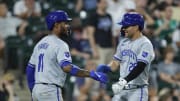 Jul 28, 2024; Chicago, Illinois, USA; Kansas City Royals third baseman Maikel Garcia (11) and second baseman Adam Frazier (26) celebrate after they both scored against the Chicago White Sox during the eight inning at Guaranteed Rate Field. Mandatory Credit: Kamil Krzaczynski-USA TODAY Sports