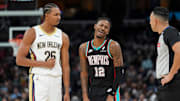 Pelicans' Trey Murphy III (25) and Grizzlies' Ja Morant (12) disagree over a foul call during the home opener against the New Orleans Pelicans at FedExForum on October 22, 2025.
