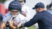 Aug 14, 2022; Nashville, Tennessee;  Tennessee Titans tight end Briley Moore (82) holds on to the ball as tight ends coach Luke Steckel tries to punch it out during a training camp practice at Ascension Saint Thomas Sports Park.  Mandatory Credit: George Walker IV-USA TODAY Sports