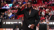 Jan 14, 2024; Miami, Florida, USA; Former Miami Heat player Dwayne Wade salutes the fans and cameras after a special ceremony during halftime of the game between the Miami Heat and the Charlotte Hornets at Kaseya Center. Mandatory Credit: Jasen Vinlove-USA TODAY Sports