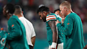 Sep 12, 2024; Miami Gardens, Florida, USA; Miami Dolphins quarterback Tua Tagovailoa (1) walks off the field with training staff after an apparent injury during the second half against the Buffalo Bills at Hard Rock Stadium.