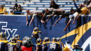 Showboats players run to celebrate with fans after they intercepted the ball during the UFL game between the San Antonio Brahmas and Memphis Showboats in Simmons Bank Liberty Stadium in Memphis, Tenn., on Saturday, April 6, 2024.