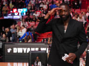 Jan 14, 2024; Miami, Florida, USA; Former Miami Heat player Dwayne Wade salutes the fans and cameras after a special ceremony during halftime of the game between the Miami Heat and the Charlotte Hornets at Kaseya Center. Mandatory Credit: Jasen Vinlove-USA TODAY Sports