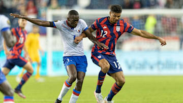 Miles Robinson shields the ball from a Haitian player during the 2021 Gold Cup.