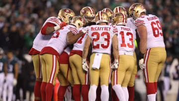 San Francisco 49ers offense huddles