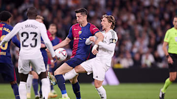 Robert Lewandowski (L) of FC Barcelona and Luka Modric (R)...