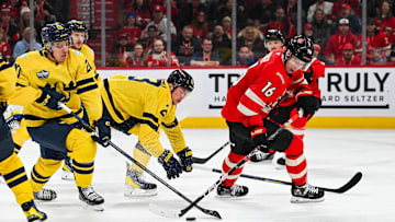 Feb 12, 2025; Montreal, Quebec, CAN; [Imagn Images direct customers only] Team Canada forward Mitch Marner (16) plays the puck as Team Sweden forward Joel Eriksson (20) defends in the first period during a 4 Nations Face-Off ice hockey game at Bell Centre. Mandatory Credit: David Kirouac-Imagn Images
