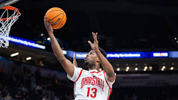 Mar 12, 2025; Indianapolis, IN, USA; Ohio State Buckeyes forward Sean Stewart (13) shoots the ball while Iowa Hawkeyes forward Ladji Dembele (13) defends in the second half  at Gainbridge Fieldhouse. Mandatory Credit: Trevor Ruszkowski-Imagn Images