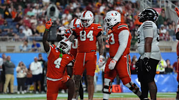 Dec 28, 2024; Orlando, FL, USA; Miami Hurricanes running back Mark Fletcher Jr. (4) celebrates after scoring a touchdown against the Iowa State Cyclones during the second half at Camping World Stadium. Mandatory Credit: Jasen Vinlove-Imagn Images