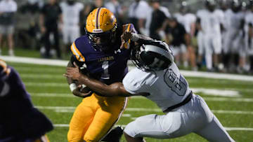 DeSoto Central’s Eric Perry (1) stiff arms Houston’s Ben Killebrew (8) as he runs with the ball during the game between Houston High School and DeSoto Central High School in Southaven, Miss., on Thursday, August 29, 2024.