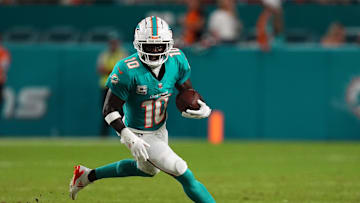 Sep 30, 2024; Miami Gardens, Florida, USA; Miami Dolphins wide receiver Tyreek Hill (10) runs with the ball during the first half against the Tennessee Titans at Hard Rock Stadium. Mandatory Credit: Jasen Vinlove-Imagn Images