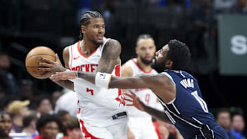 Oct 31, 2024; Dallas, Texas, USA;  Houston Rockets guard Jalen Green (4) looks to pass as Dallas Mavericks guard Kyrie Irving (11) defends during the second half at American Airlines Center. Mandatory Credit: Kevin Jairaj-Imagn Images
